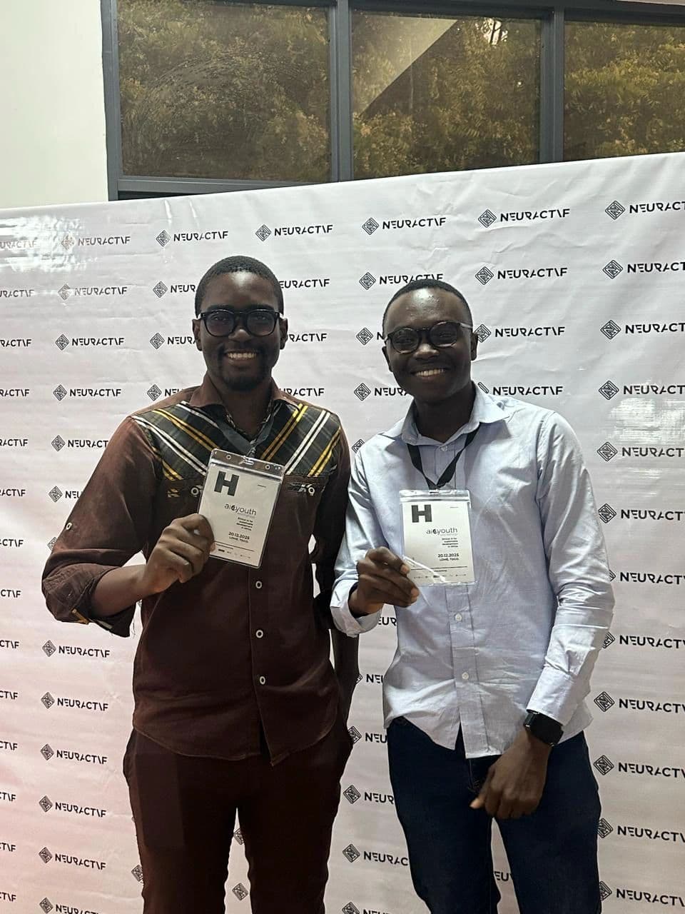 Ewan Semadegbe and Eli Jean Doumeyan showing their AI4YOUTH hackathon badges.